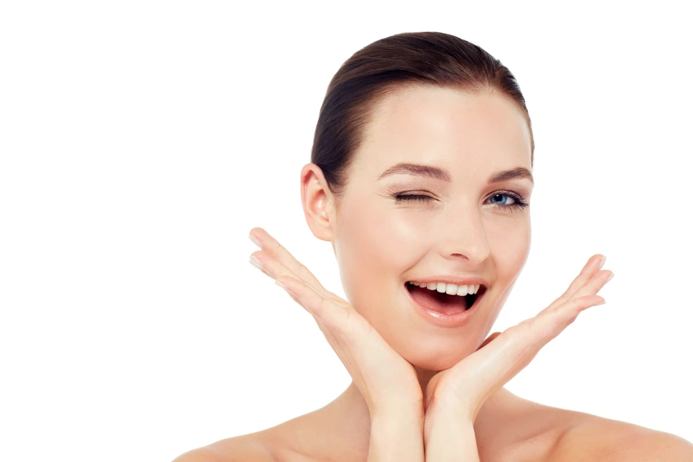 Smiling woman with smooth glowing skin after laser therapy.