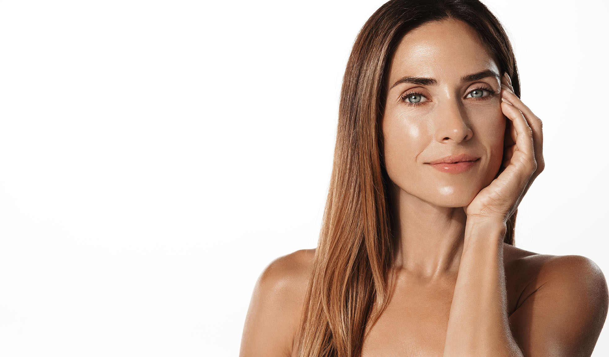 Woman with radiant skin after injectables session.