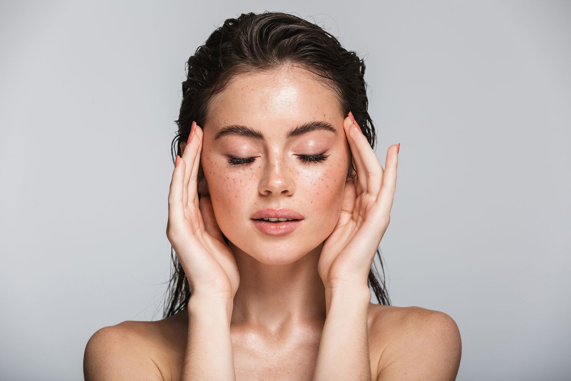 Woman with radiant skin showing amazing effects of microneedling.